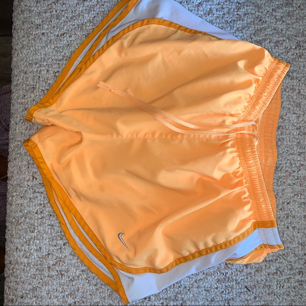 Orange Nike running shorts